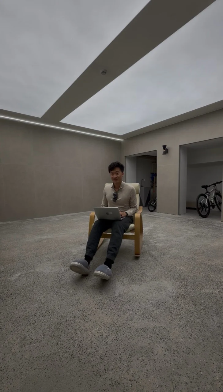 Linhan seated with his laptop, working on a design